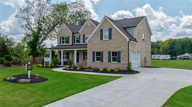 a front view of a house with a garden and deck