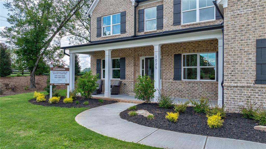 1025 Stonewood Field Road Watkinsville, GA 30677 - Photo 14 of 98 a front view of a house with a garden and plants