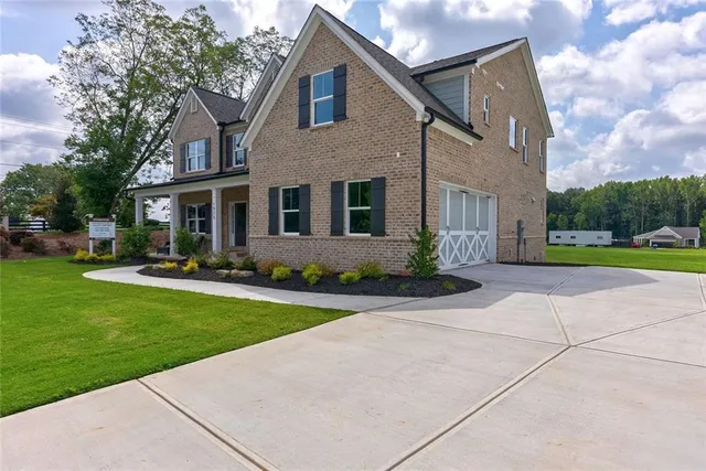 a front view of a house with a yard and porch