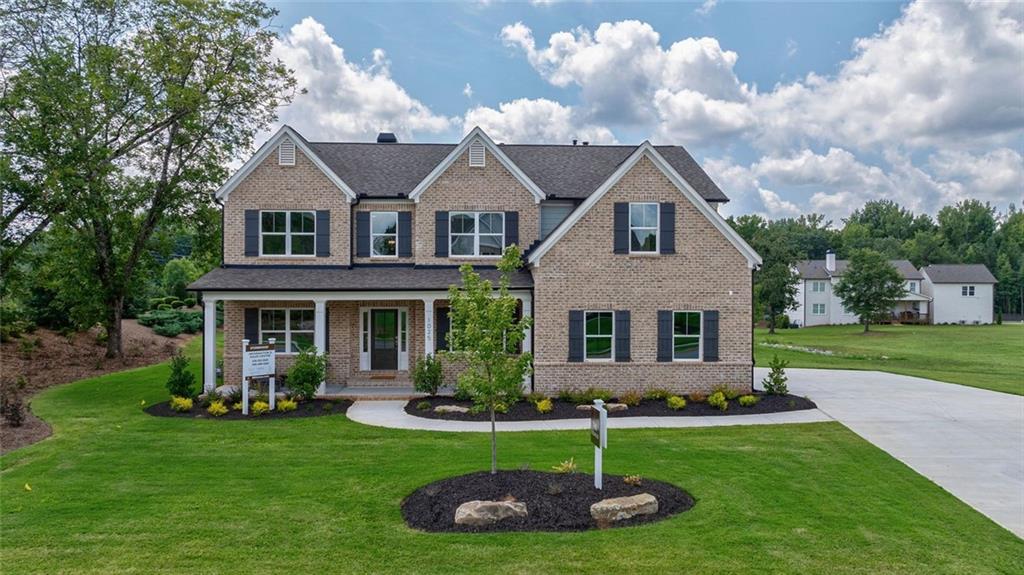 1025 Stonewood Field Road Watkinsville, GA 30677 - Photo 33 of 98 a front view of a house with a yard and garage