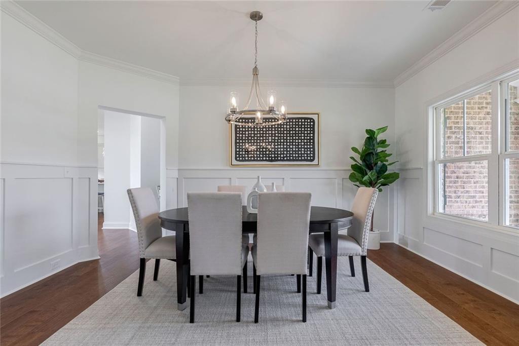 1025 Stonewood Field Road Watkinsville, GA 30677 - Photo 35 of 98 a view of a dining room with furniture window and wooden floor