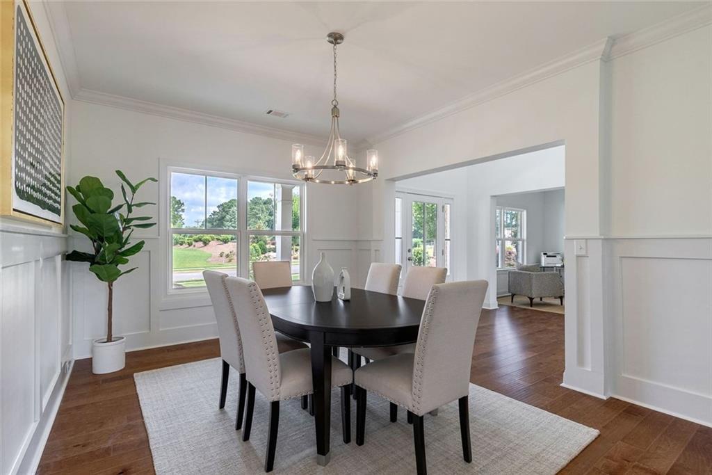 1025 Stonewood Field Road Watkinsville, GA 30677 - Photo 36 of 98 a view of a dining room with furniture window and wooden floor