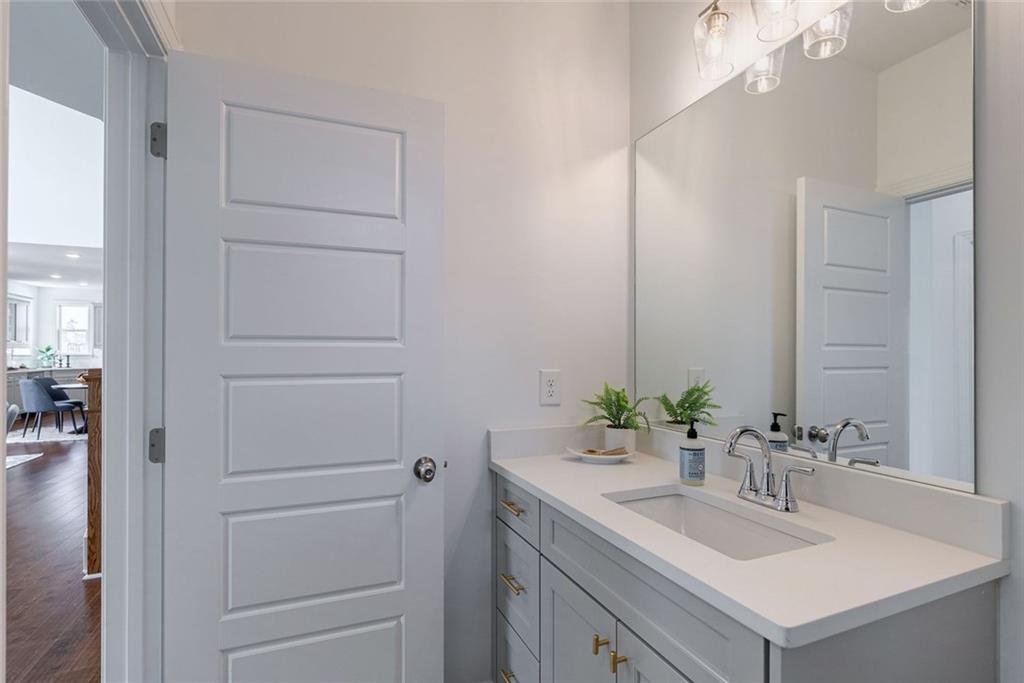 1025 Stonewood Field Road Watkinsville, GA 30677 - Photo 39 of 98 a bathroom with a sink vanity and a mirror