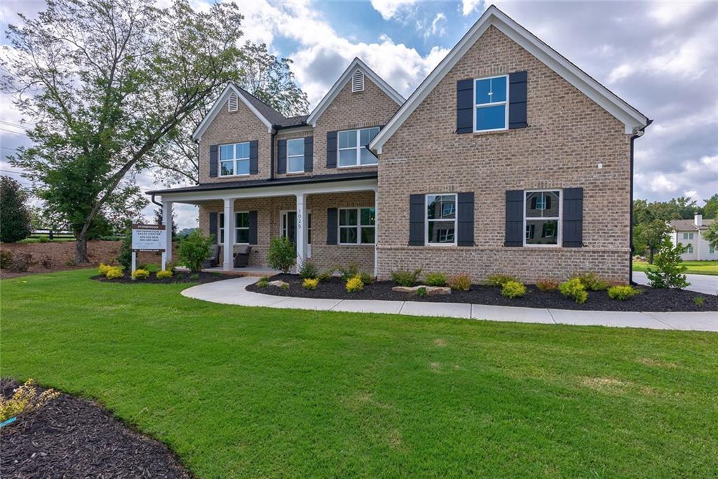 1025 Stonewood Field Road Watkinsville, GA 30677 - Photo 4 of 98 a front view of a house with a yard and porch