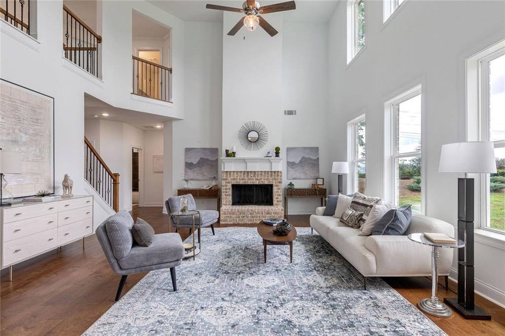 1025 Stonewood Field Road Watkinsville, GA 30677 - Photo 44 of 98 a living room with furniture a fireplace and a table