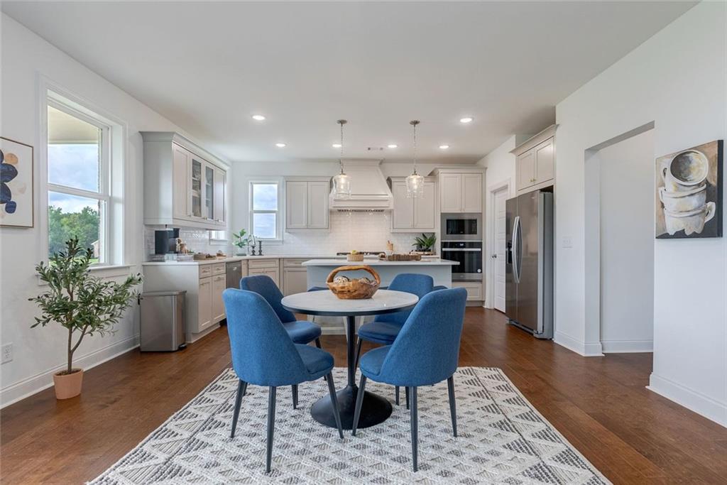 1025 Stonewood Field Road Watkinsville, GA 30677 - Photo 47 of 98 a view of kitchen with refrigerator stove dining table and chairs