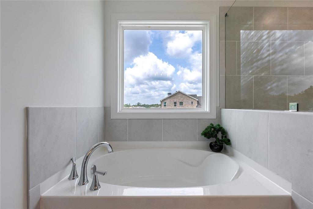 1025 Stonewood Field Road Watkinsville, GA 30677 - Photo 74 of 98 a white bath tub sitting in a bathroom with a tub