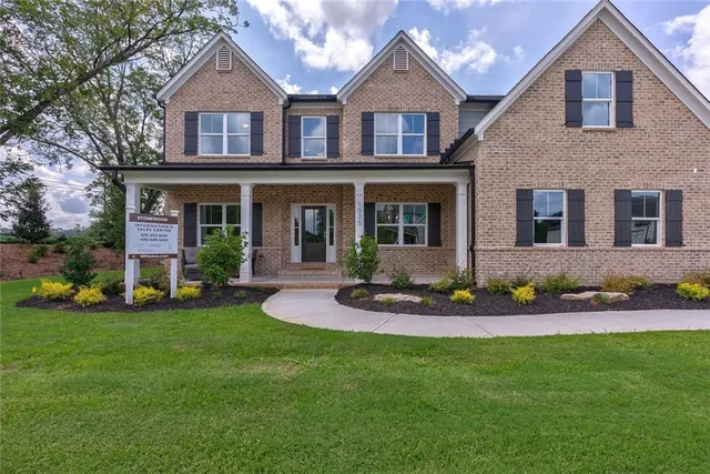 a front view of a house with garden
