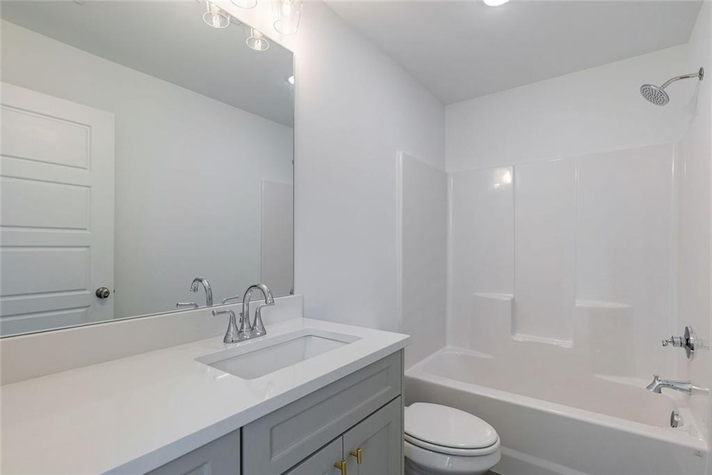 1025 Stonewood Field Road Watkinsville, GA 30677 - Photo 81 of 98 a bathroom with a sink toilet vanity and shower
