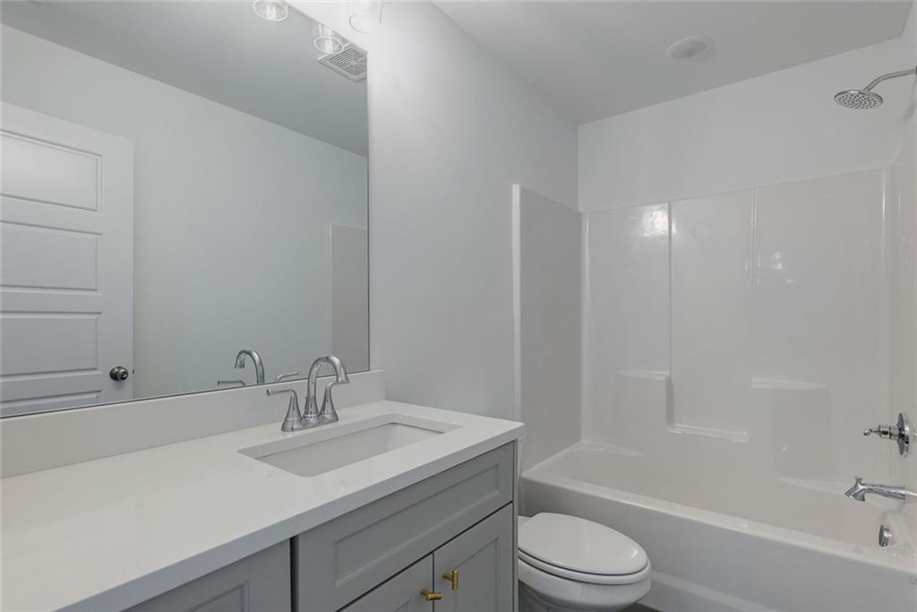 1025 Stonewood Field Road Watkinsville, GA 30677 - Photo 85 of 98 a bathroom with a sink toilet vanity and shower