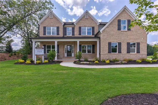 a front view of a house with a yard and garage