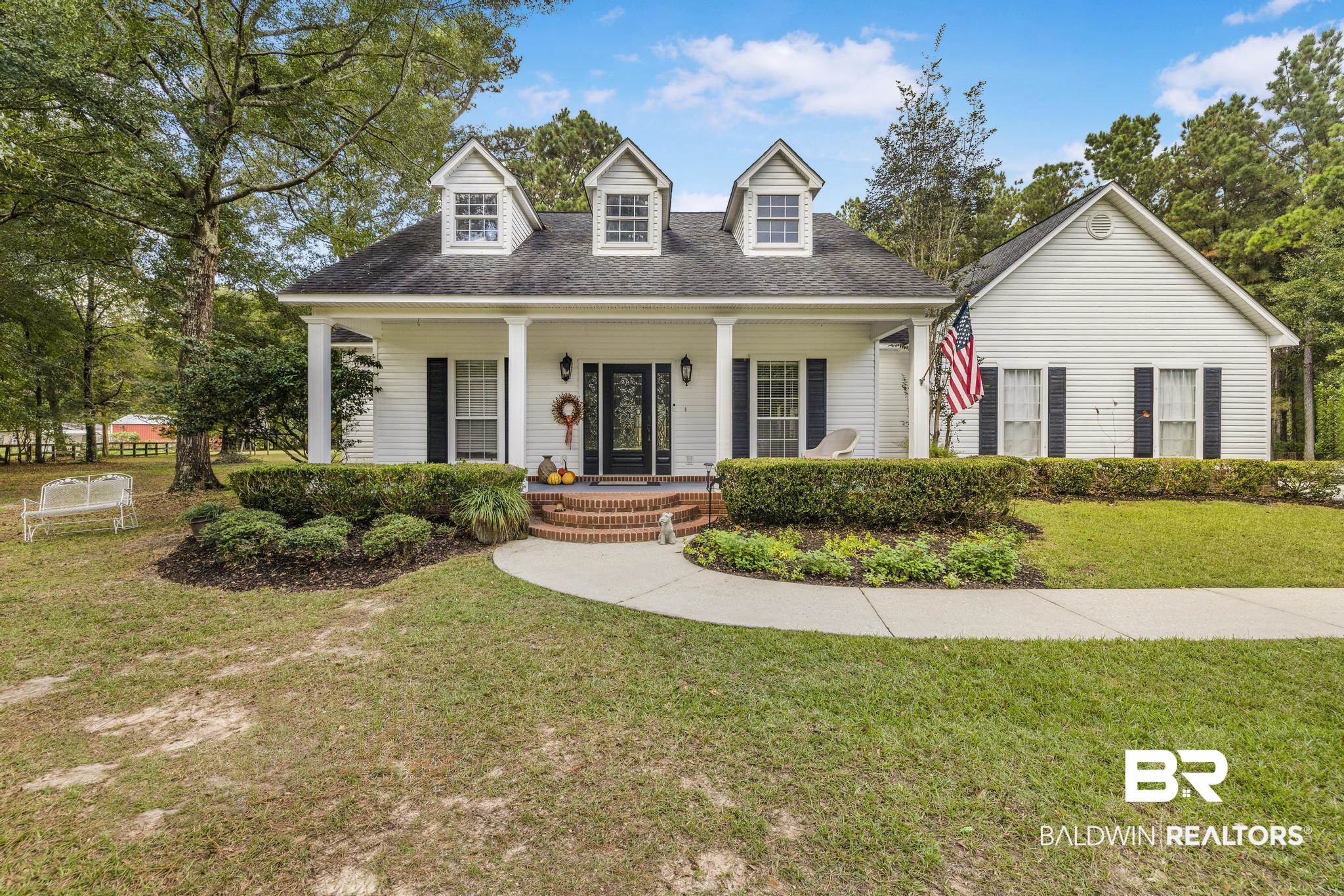10603 Old Stage Road Stockton, AL 36579 - Photo 4 of 34 New england style home with a front lawn, covered porch, and a shingled roof