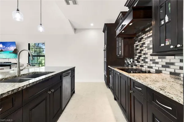 a kitchen with counter top space and sink