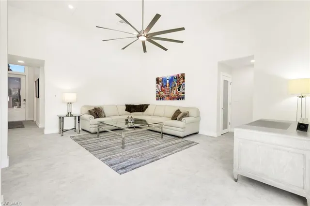 a living room with furniture and a ceiling fan