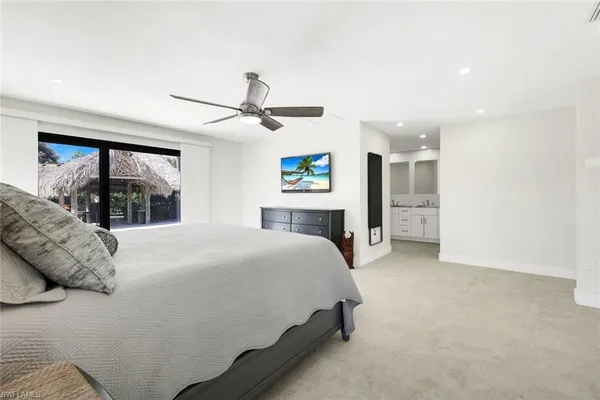 a spacious bedroom with a large bed and a large window