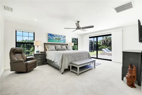 a bedroom with a bed couch and window