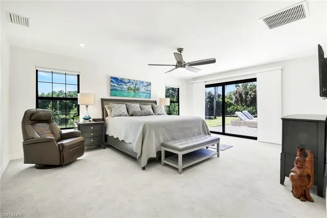 a bedroom with a bed couch and window