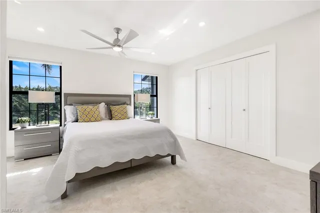 a bedroom with a large bed and a window