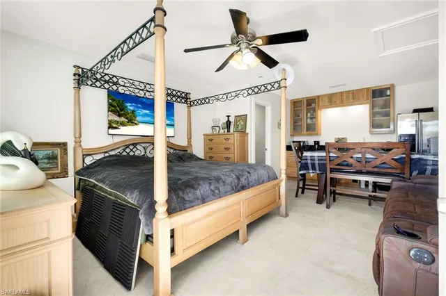 a living room with a bed furniture and a window