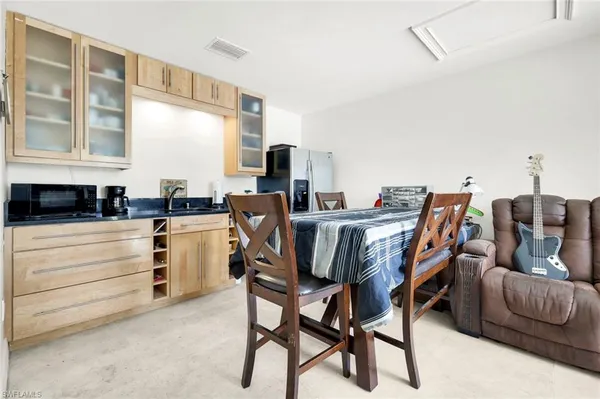 a view of a dining room with furniture and a window