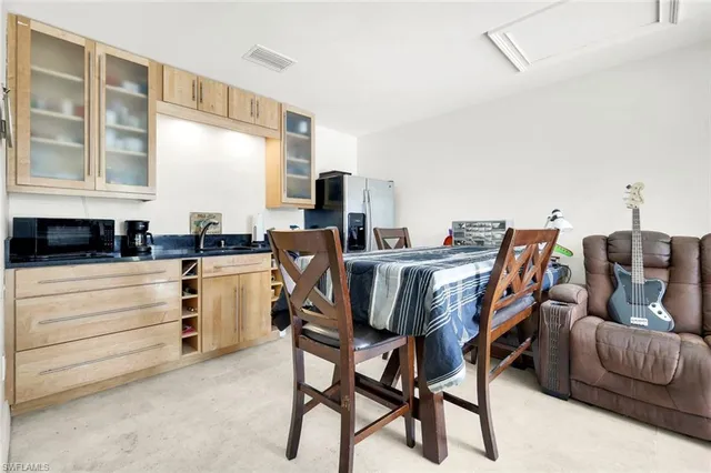 a view of a dining room with furniture and a window