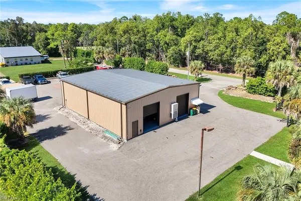 an aerial view of a house with porch yard basket ball court and trampoline