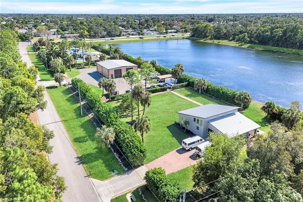 an aerial view of a house with garden space and lake view