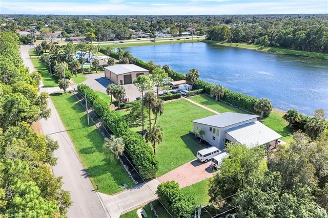 an aerial view of a house with garden space and lake view