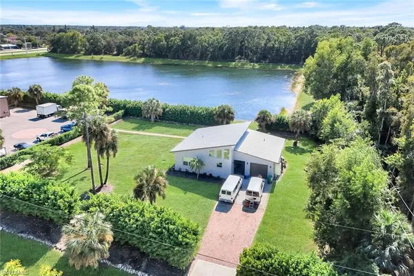 an aerial view of a house with garden space and a lake view