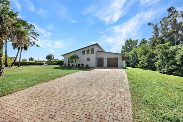 a front view of house with yard and green space
