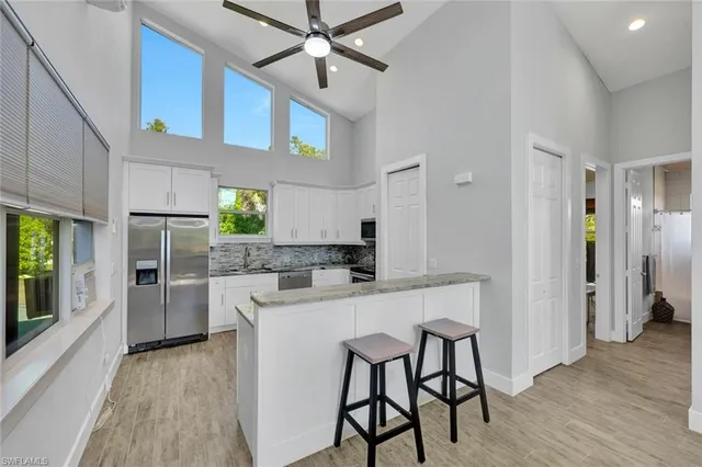 a kitchen with stainless steel appliances a table and chairs in it