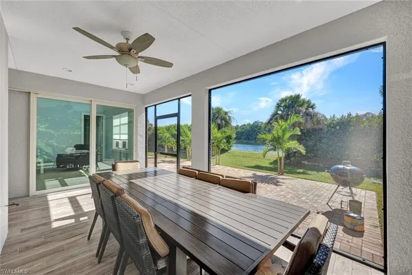 a living room with a large window with table and chairs
