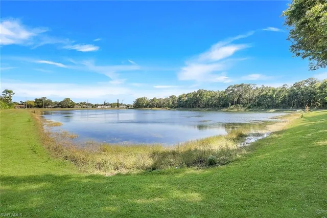 a view of a lake with houses in the back