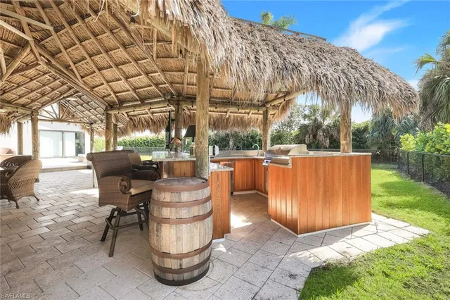 a view of backyard with barbeque grill and outdoor seating