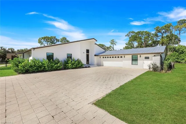 a view of house with outdoor space and garden