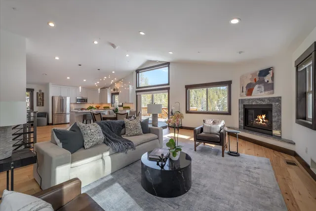 a living room with furniture kitchen view and a fireplace