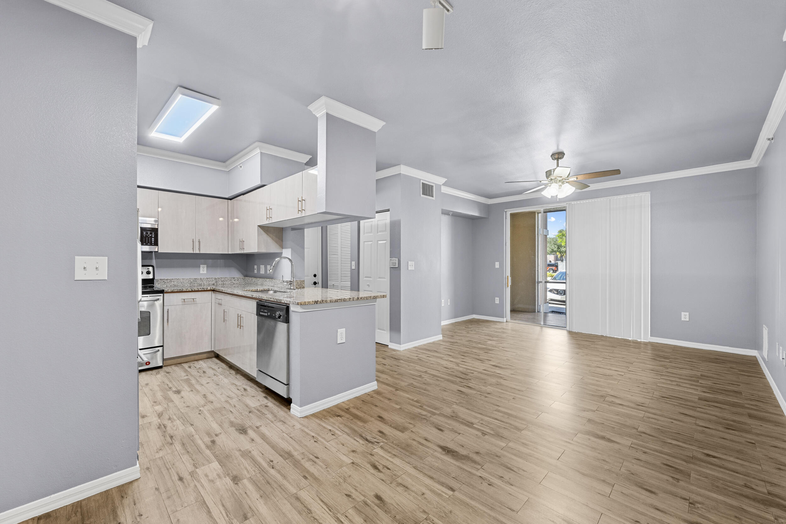 6410 Emerald Dunes Drive, Unit 101 West Palm Beach, FL 33411 - Photo 1 of 39 a large kitchen with stainless steel appliances a large counter top a sink a stove and a refrigerator