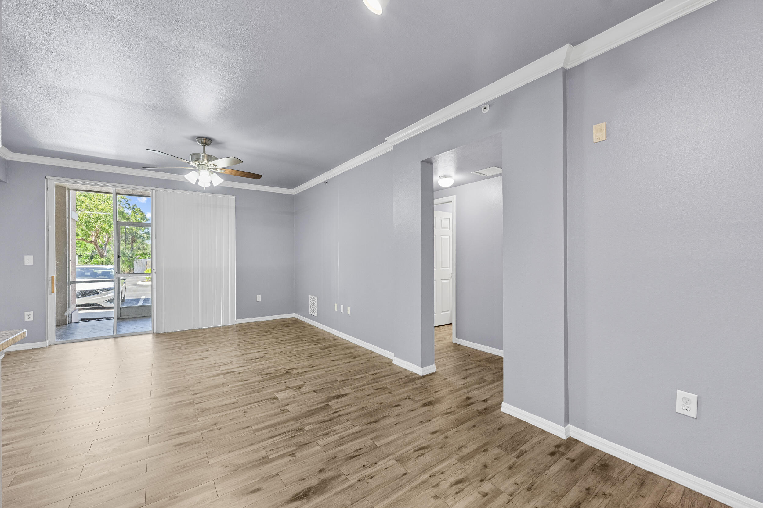 6410 Emerald Dunes Drive, Unit 101 West Palm Beach, FL 33411 - Photo 11 of 39 a view of an empty room with window and wooden floor