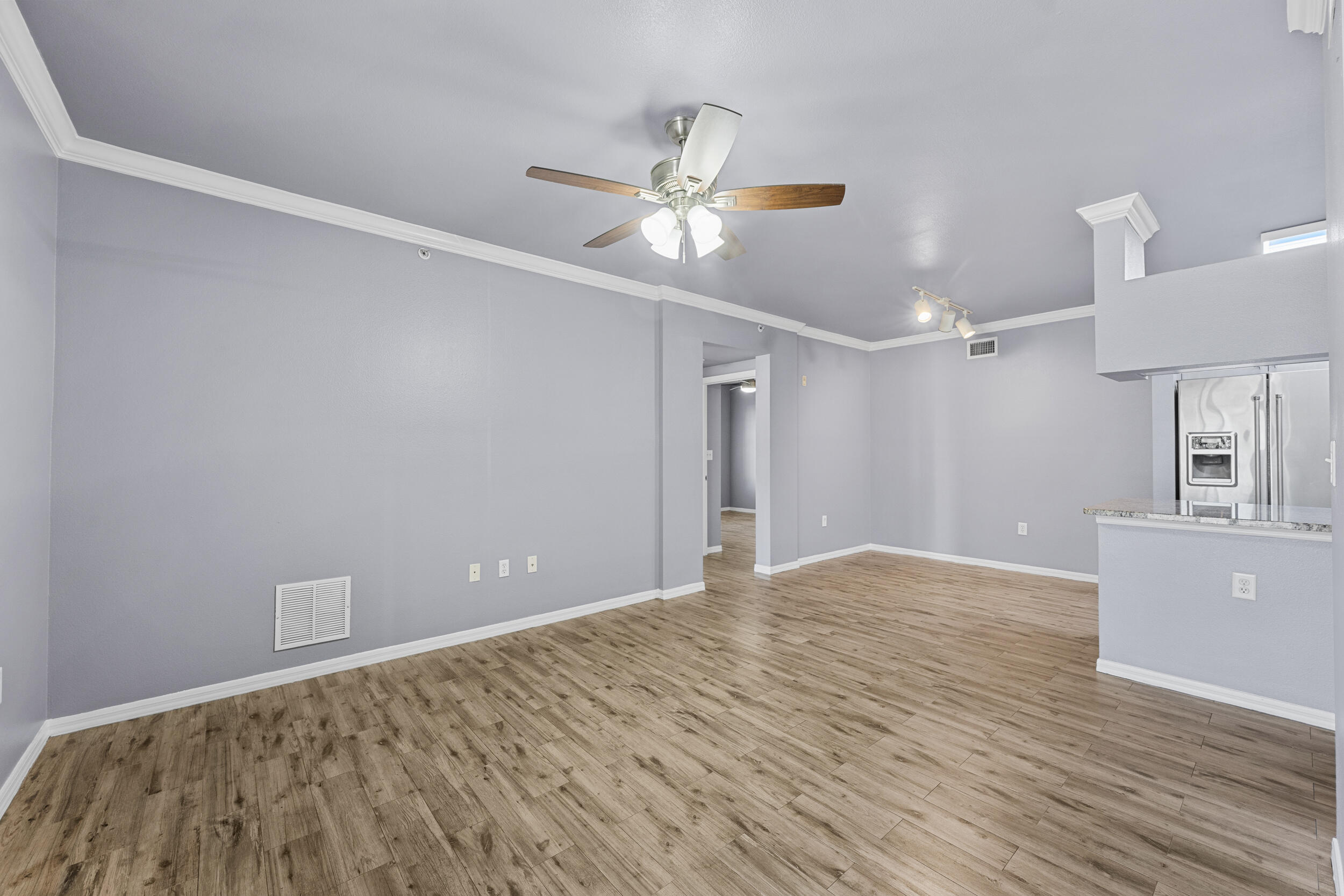 6410 Emerald Dunes Drive, Unit 101 West Palm Beach, FL 33411 - Photo 13 of 39 a view of a livingroom with a ceiling fan and wooden floor