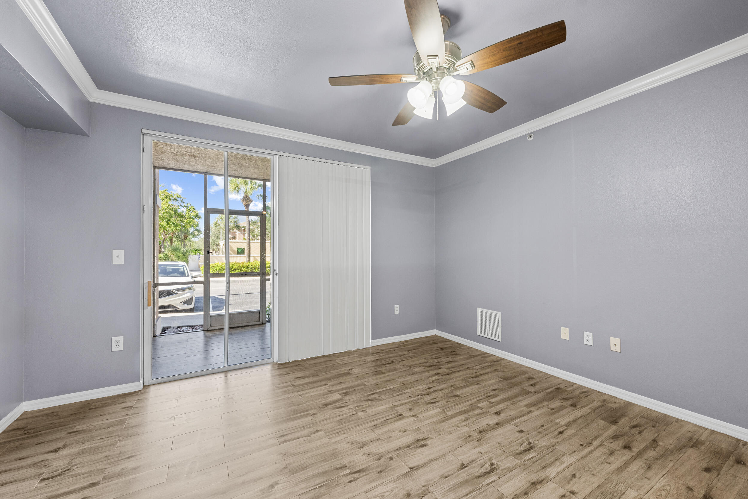 6410 Emerald Dunes Drive, Unit 101 West Palm Beach, FL 33411 - Photo 15 of 39 wooden floor in an empty room with a window