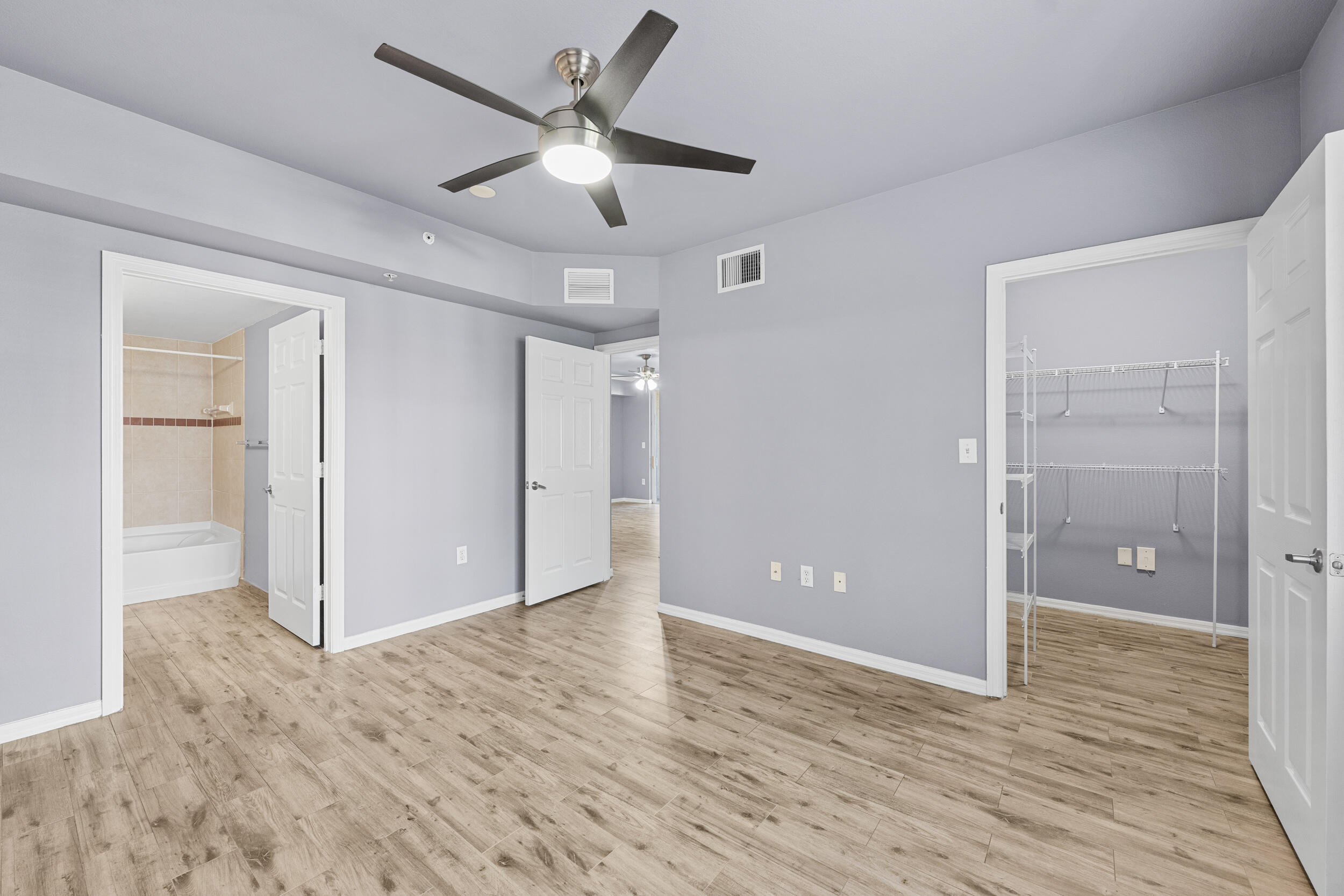 6410 Emerald Dunes Drive, Unit 101 West Palm Beach, FL 33411 - Photo 17 of 39 wooden floor in an empty room with a window