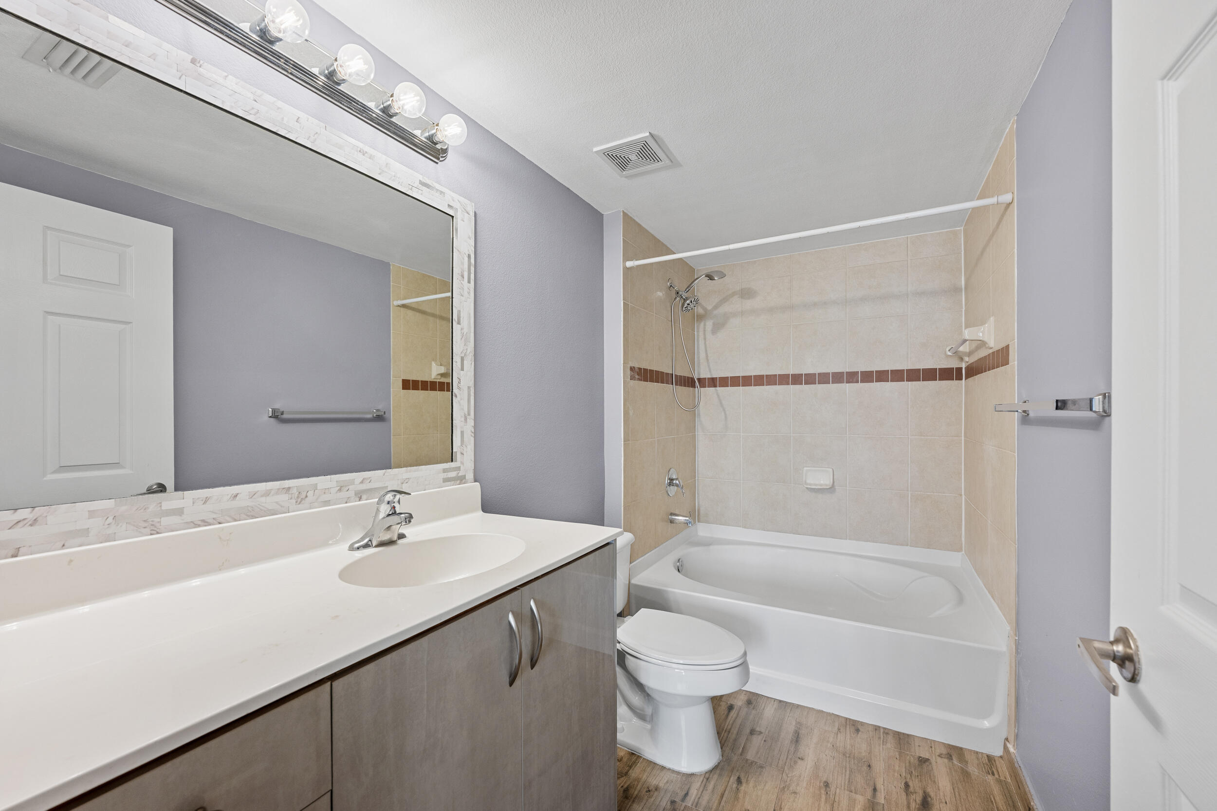 6410 Emerald Dunes Drive, Unit 101 West Palm Beach, FL 33411 - Photo 18 of 39 a bathroom with a sink a toilet and shower