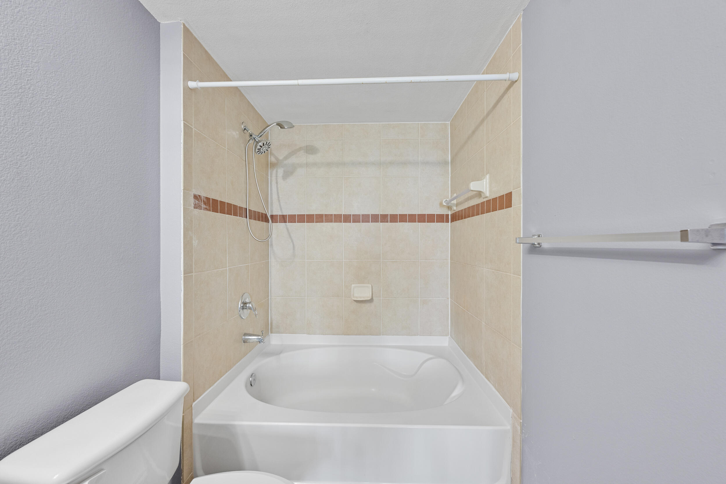 6410 Emerald Dunes Drive, Unit 101 West Palm Beach, FL 33411 - Photo 19 of 39 a bathroom with a bathtub and a shower