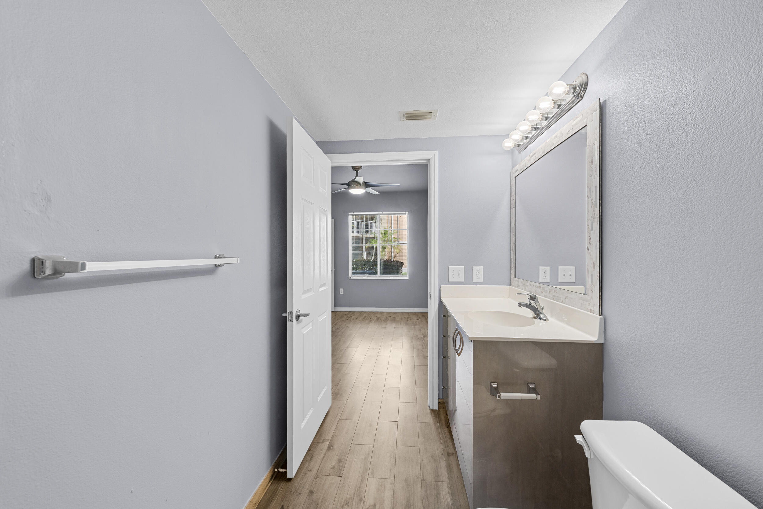 6410 Emerald Dunes Drive, Unit 101 West Palm Beach, FL 33411 - Photo 20 of 39 a bathroom with a sink a toilet and shower