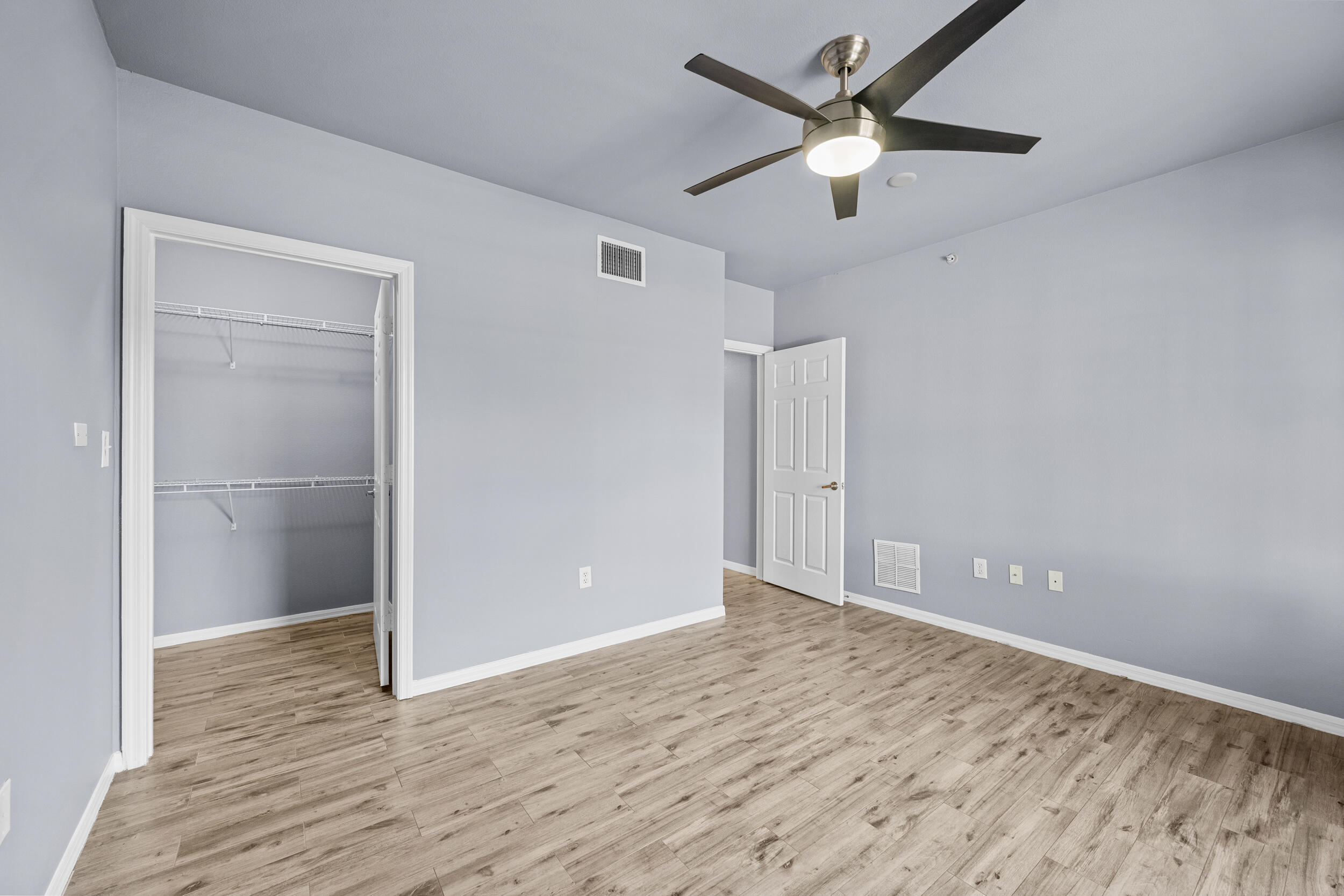 6410 Emerald Dunes Drive, Unit 101 West Palm Beach, FL 33411 - Photo 26 of 39 a view of an empty room with wooden floor