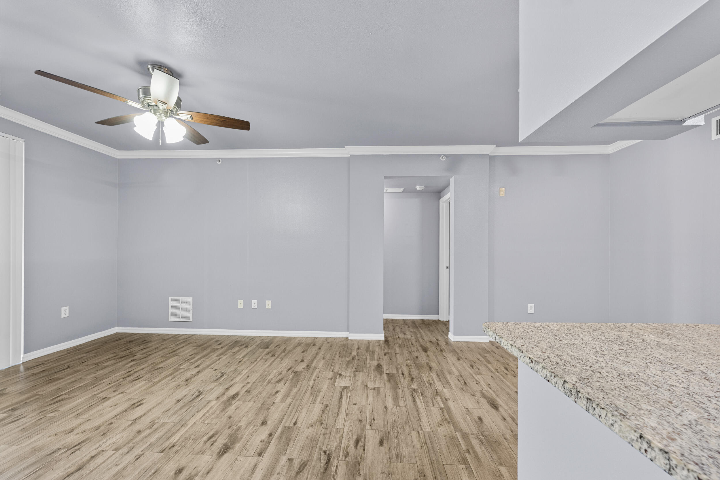 6410 Emerald Dunes Drive, Unit 101 West Palm Beach, FL 33411 - Photo 3 of 39 wooden floor in an empty room