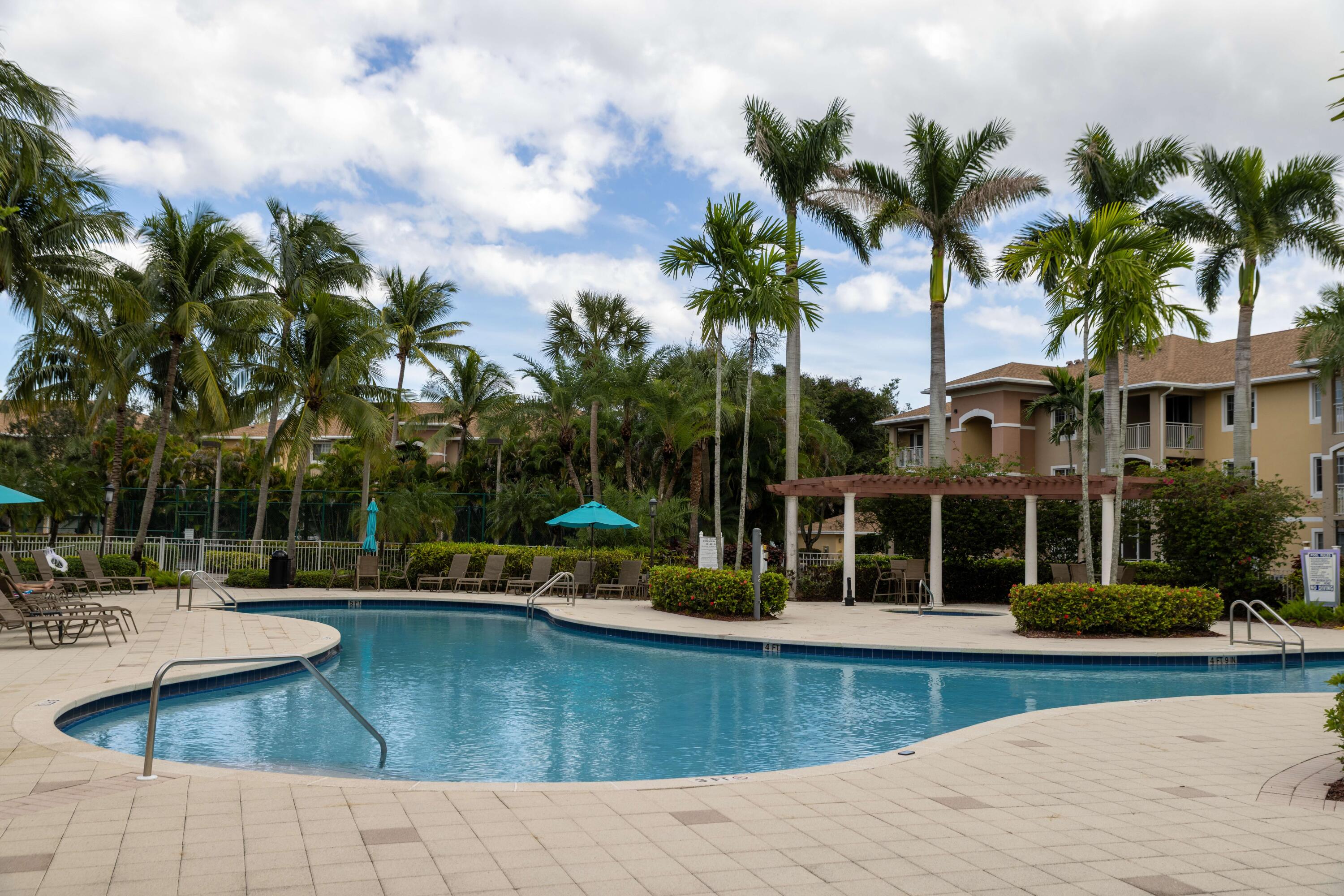 6410 Emerald Dunes Drive, Unit 101 West Palm Beach, FL 33411 - Photo 33 of 39 a view of a house with swimming pool and sitting area
