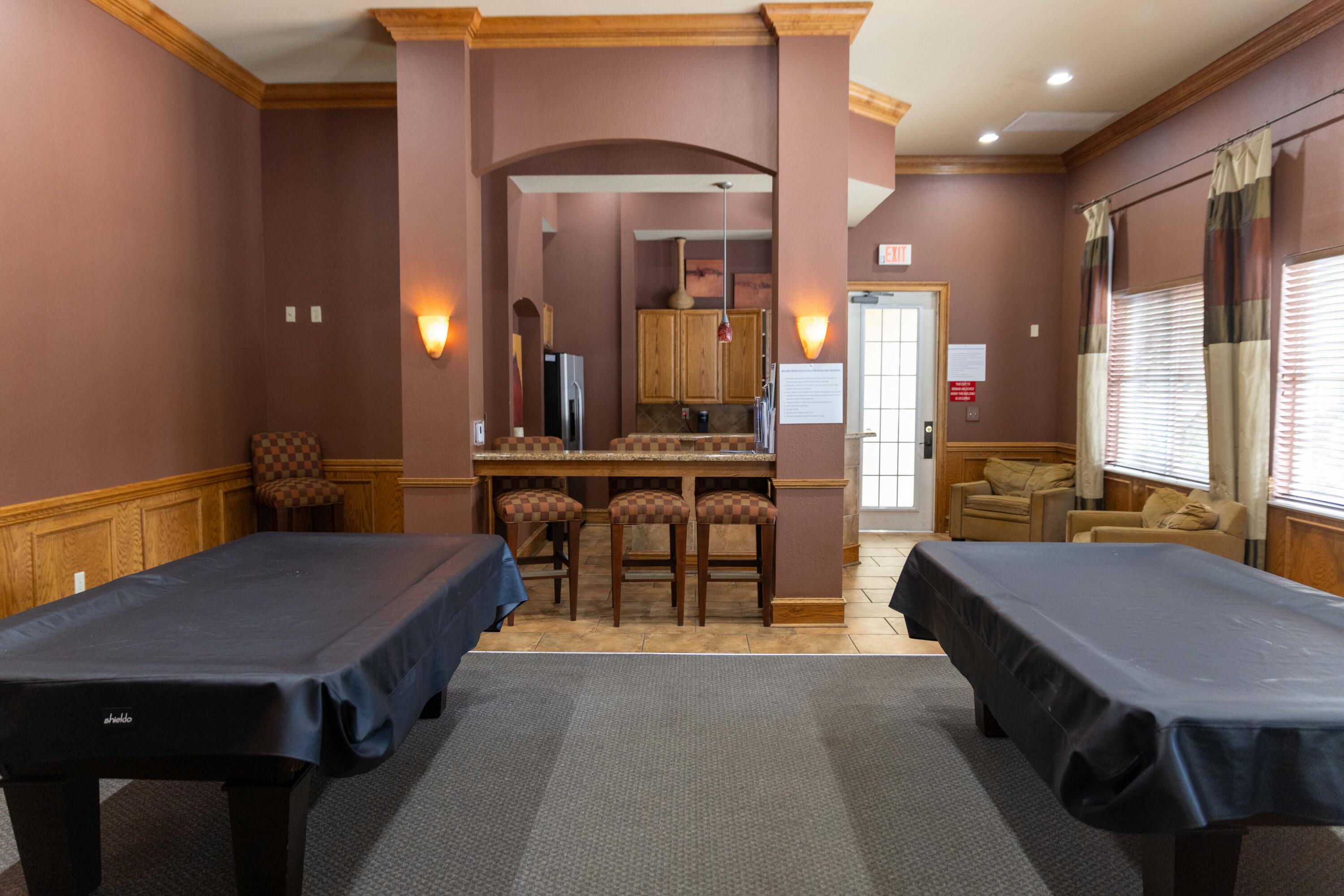 6410 Emerald Dunes Drive, Unit 101 West Palm Beach, FL 33411 - Photo 36 of 39 a living room with a table chairs and a kitchen view