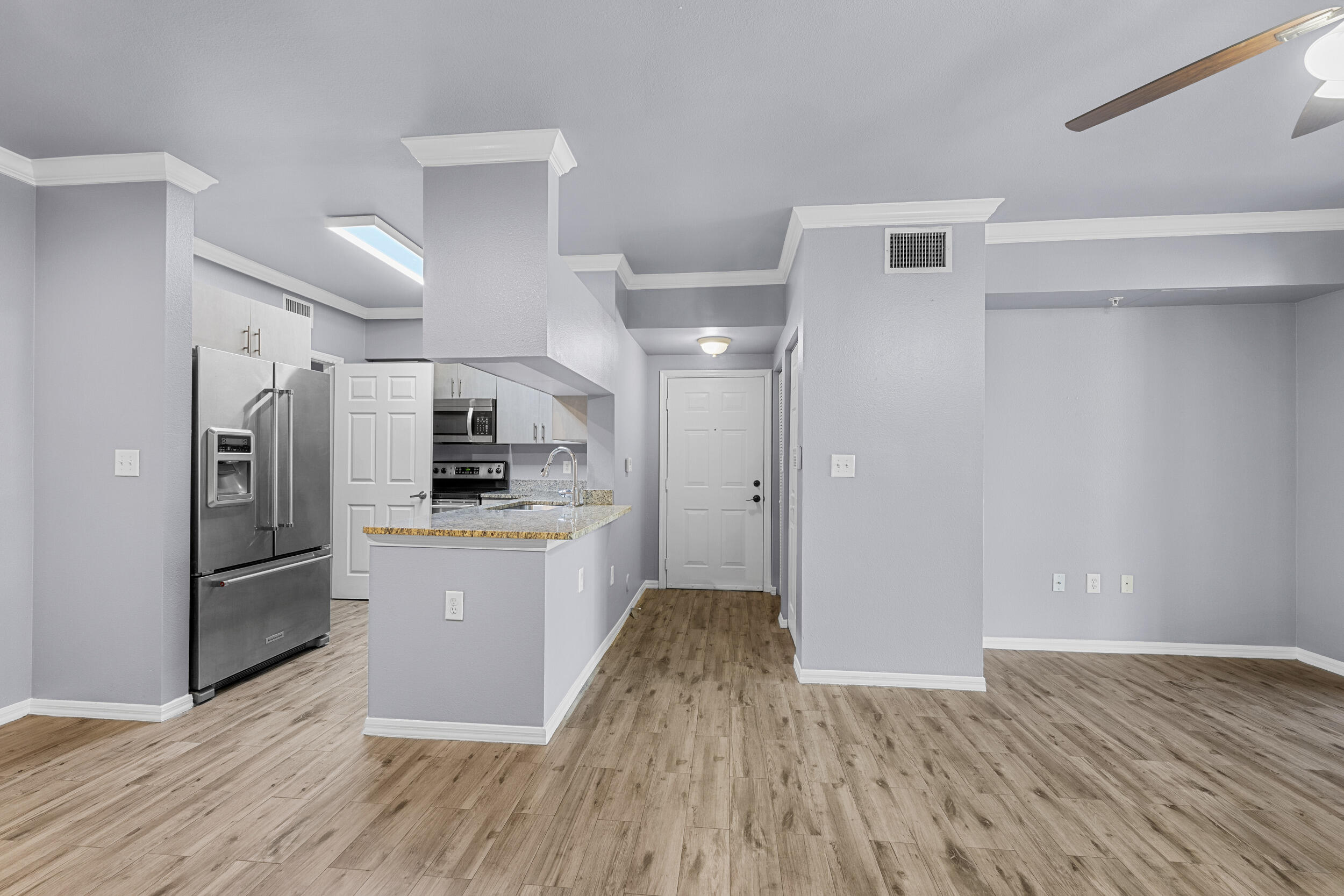 6410 Emerald Dunes Drive, Unit 101 West Palm Beach, FL 33411 - Photo 6 of 39 a kitchen with stainless steel appliances a refrigerator sink and microwave