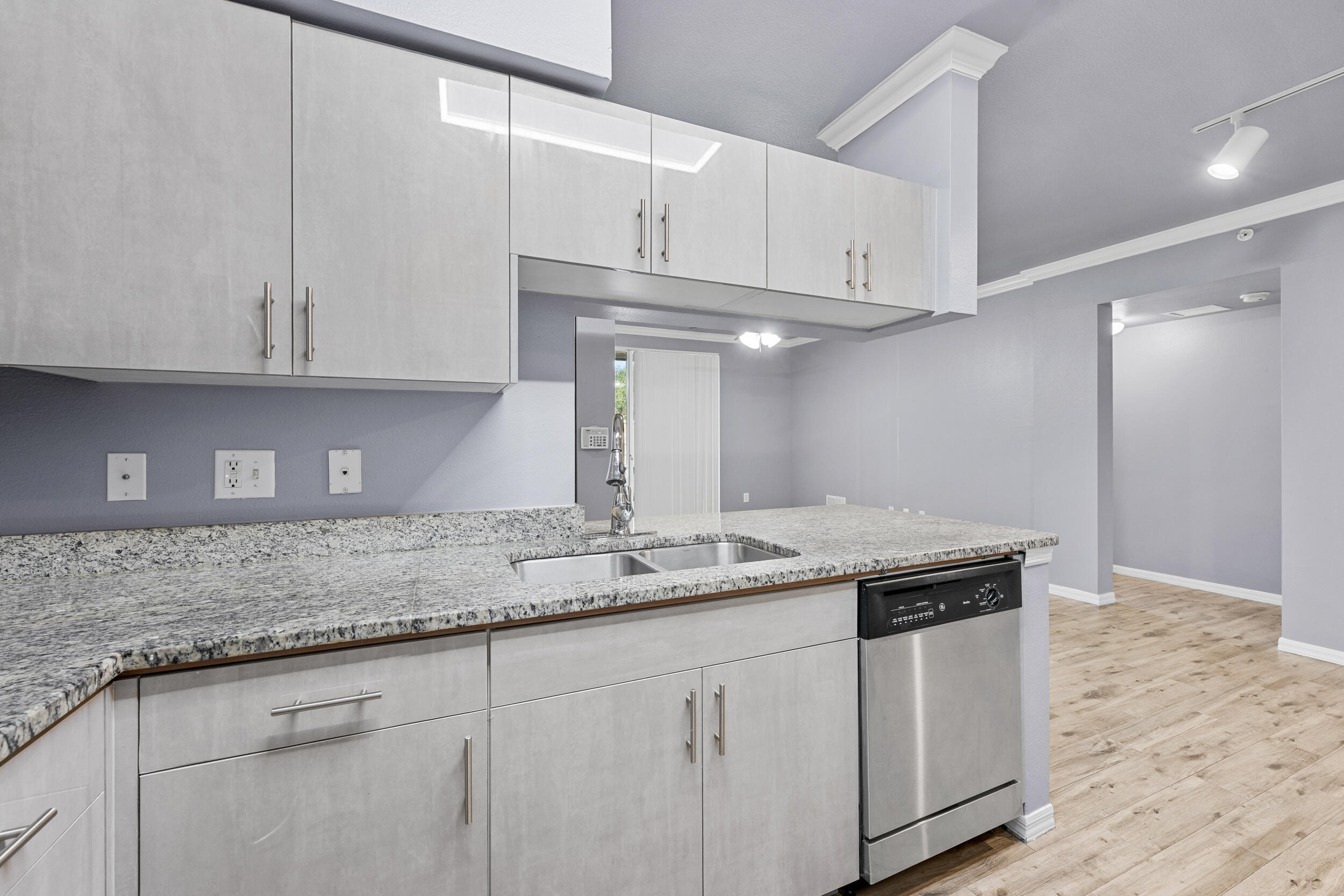 6410 Emerald Dunes Drive, Unit 101 West Palm Beach, FL 33411 - Photo 8 of 39 a kitchen with stainless steel appliances granite countertop a sink and cabinets